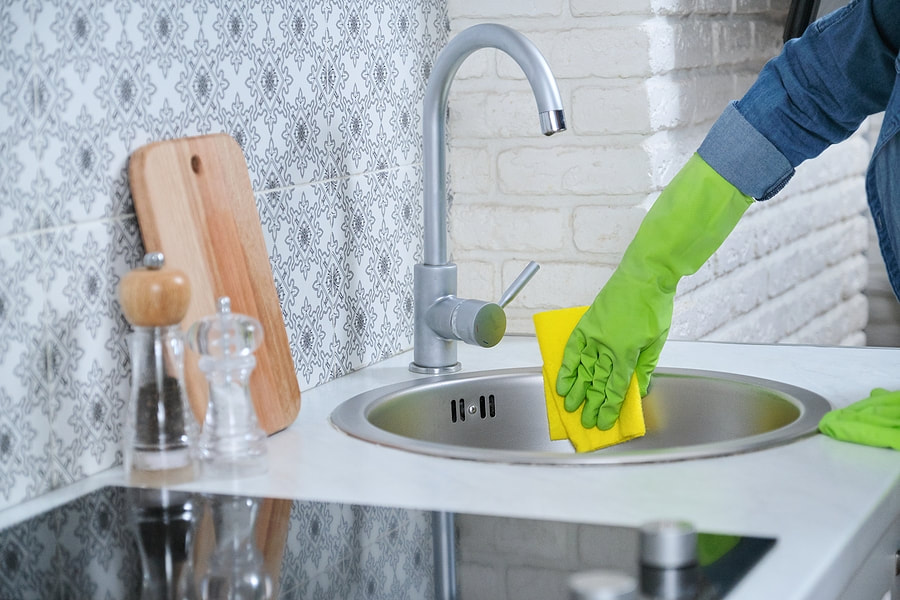 woman cleaning the sink